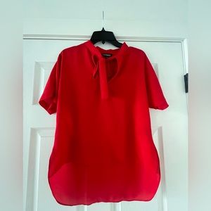 Express red blouse with a bow